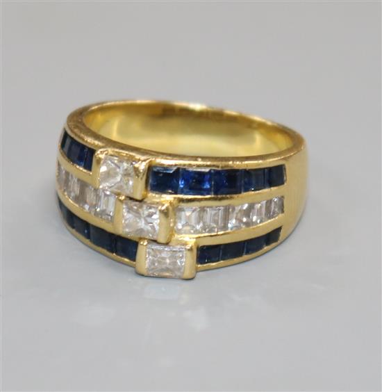 A modern 18ct gold and triple row sapphire and diamond channel set dress ring,